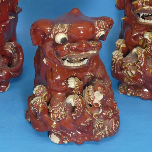 44 - Three antique Chinese pottery Kylins, all holding a smaller Kylin, all damaged, 27cm tall (3)... 