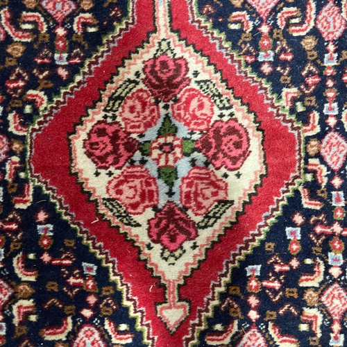 281 - Tribal Rugs: a Persian Senneh hand knotted narrow wool runner, blue ground with dark pink borders, t... 