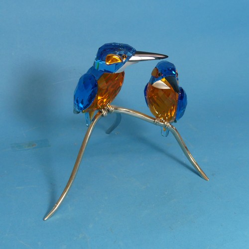 112 - A Swarovski Crystal Kingfisher Duo, the two cut glass birds, perched upon metal branch, impressed wi... 