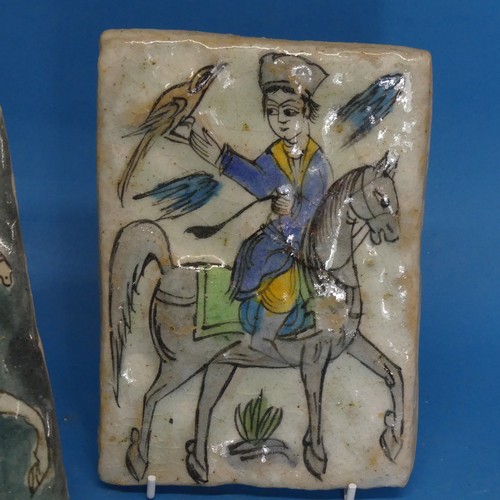 115 - A pair of 19thC Persian Tiles, depicting a horse rider catching birds, somewhat in relief, 13cm x 18... 