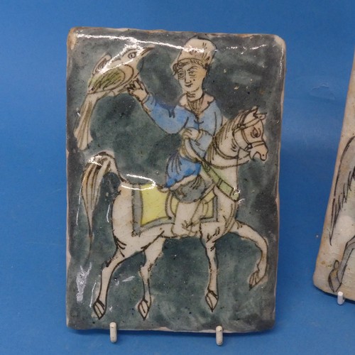 115 - A pair of 19thC Persian Tiles, depicting a horse rider catching birds, somewhat in relief, 13cm x 18... 