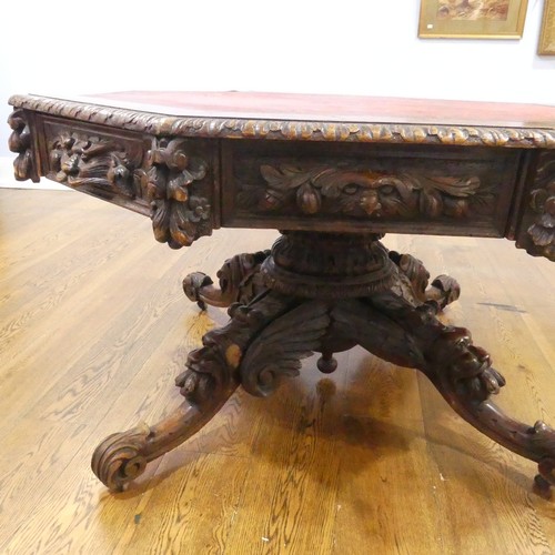 328 - A Victorian heavily carved oak octagonal Drum Table, with octagonal skived in tooled leather top abo... 