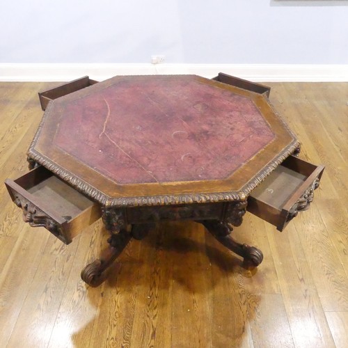 328 - A Victorian heavily carved oak octagonal Drum Table, with octagonal skived in tooled leather top abo... 