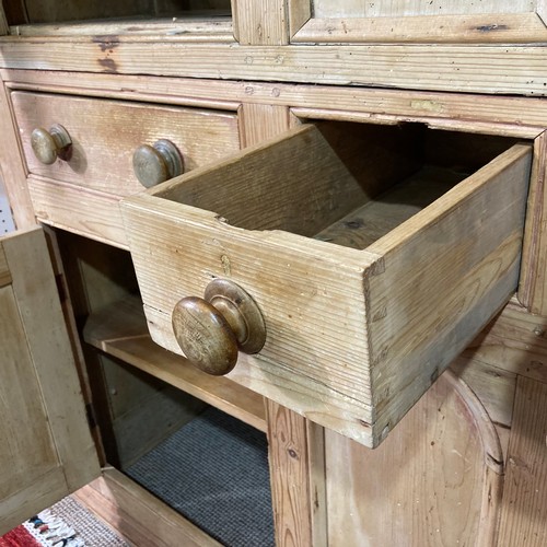 335 - A 19thC pine Housekeepers Cupboard, four cupboard doors enclosing shelves with three central drawers... 