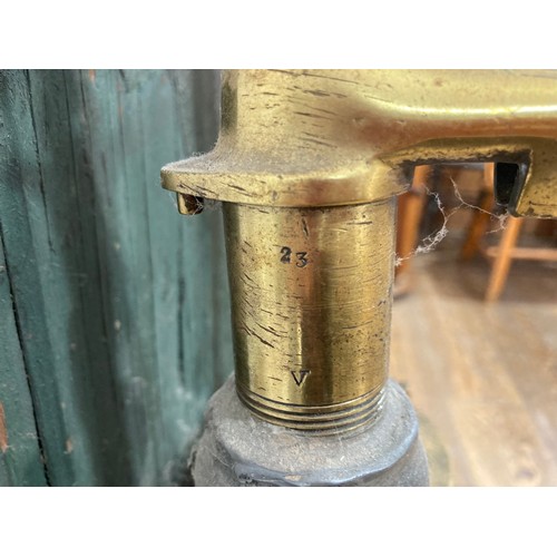 343 - A 19thC standing brass and iron hand-operated Water Pump, on green painted back board, H 155cm x W31... 