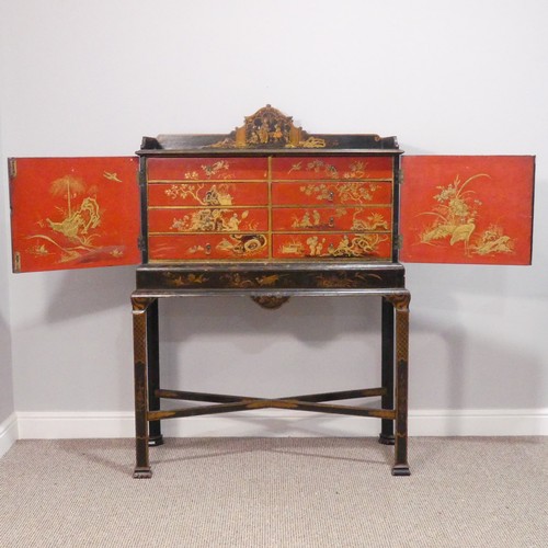 374 - An early 20thC Chinoiserie Chest on Stand, the exterior in black and gold lacquer, decorated with or... 