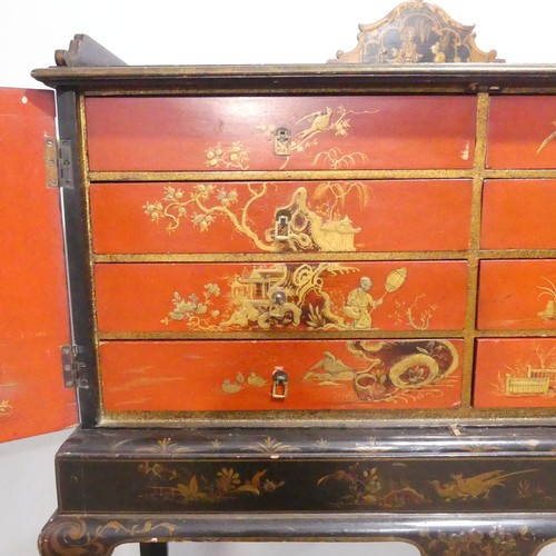 374 - An early 20thC Chinoiserie Chest on Stand, the exterior in black and gold lacquer, decorated with or... 