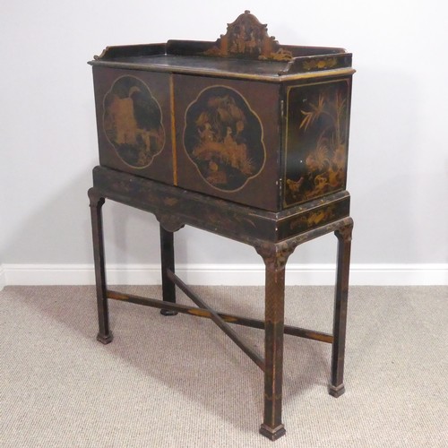 374 - An early 20thC Chinoiserie Chest on Stand, the exterior in black and gold lacquer, decorated with or... 