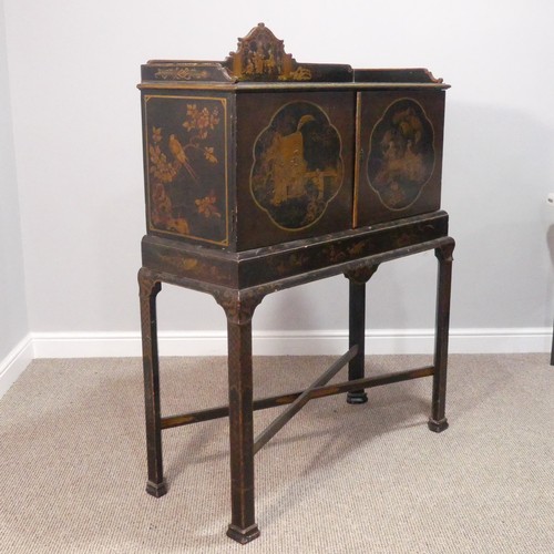 374 - An early 20thC Chinoiserie Chest on Stand, the exterior in black and gold lacquer, decorated with or... 