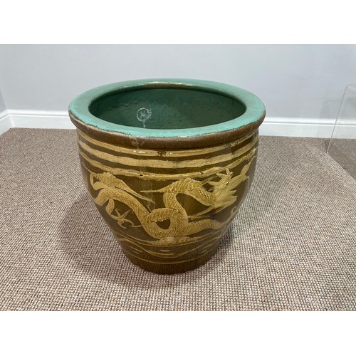 161 - A large Chinese brown glaze pottery Jardiniere, decorated in dragons with yellows, interior celadon ... 