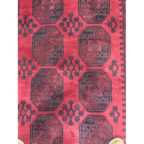 284 - Tribal Rugs: a good red ground Afghan hand knotted Carpet, the whole finely woven with tekke and gul... 