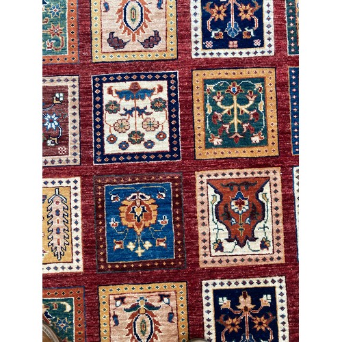 287 - Tribal Rugs; a superb hand-knotted Zeigler carpet, with dark red ground woven all over with squares ... 