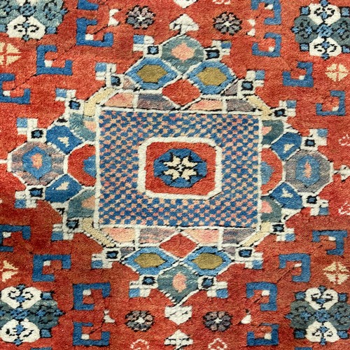 289 - Tribal Rugs: a Turkish hand knotted wool rug, the orange ground woven with bold geometric patterns i... 