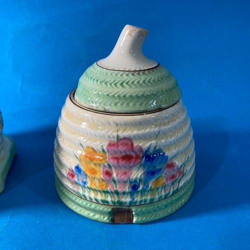 82 - A Clarice Cliff 'Spring Crocus' pattern Honey Pot, with green banding, marls for Newport, together w... 