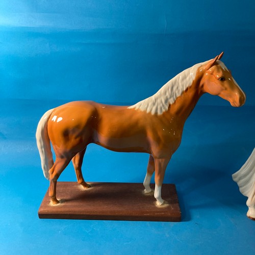 86 - A Beswick pottery Horse, mounted on a plinth, factory stamp to base, has been mounted amateurly, 32c... 