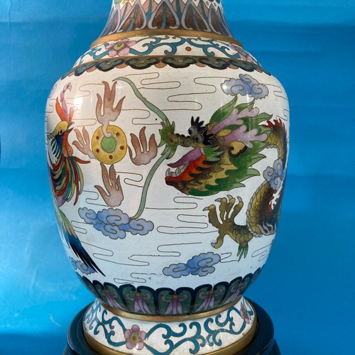 100 - A large 20thC Chinese Cloisonné Vase, depicting a dragon amongst flora and fauna, raised on an orien... 