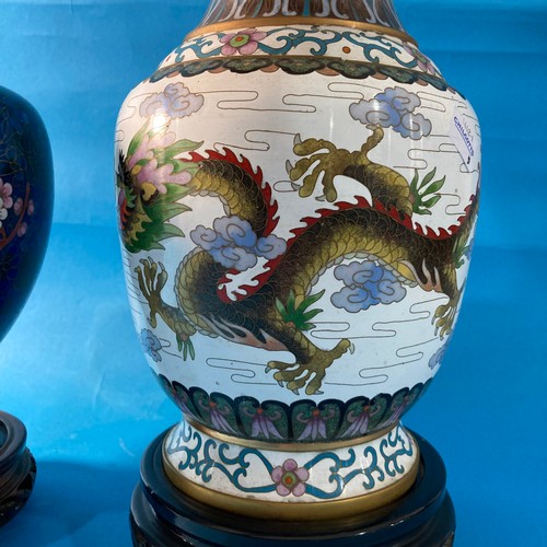 100 - A large 20thC Chinese Cloisonné Vase, depicting a dragon amongst flora and fauna, raised on an orien... 