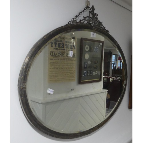 326 - A pair of early 20thC oval Wall Mirrors, with silver-plated frames enclosing the bevel edged plate, ... 