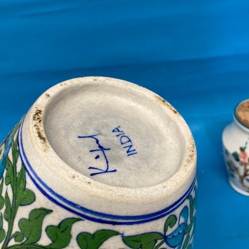 185 - A large Indian pottery Ginger Jar, decorated in colourful flora and fauna, with cover, signed to bas... 