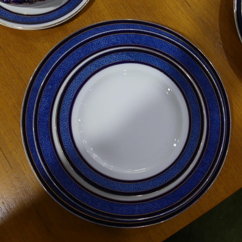 116 - An early 20thC Staffordshire Dinner Service, decorated in blue banding with gilding, comprising five... 