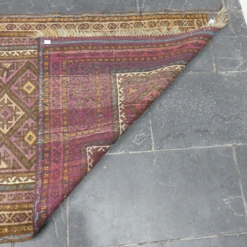 282 - Tribal rugs; a Belouchi prayer rug, buff ground with pink and blue geometric patterns, 88cm x 129cm.... 