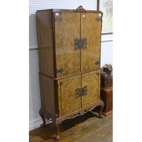 324 - A mid 20thC burr walnut Cocktail Cabinet, with 'Maple' makers label, the fitted interior with mirror... 