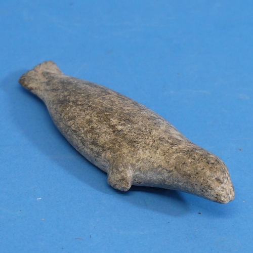 352 - A 20thC Inuit stone carving of a walrus, with bone tusks, L 13cm, together with an Inuit stone carvi... 