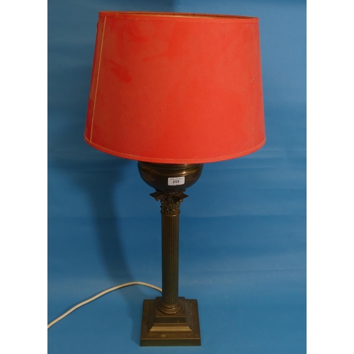 355 - An early 20thC brass column Oil Lamp, H 59cm, later fitted with electricity, with a red lampshade (2... 