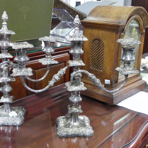 400 - A pair of silver plated three light Candelabra, 34cm high, one with a damaged sconce (2)... 