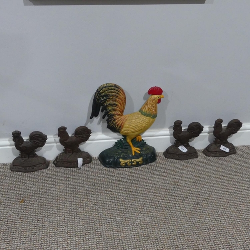 409 - A vintage cast iron Doorstop, modelled as a Cockerel, together with four further, also modelled as c... 