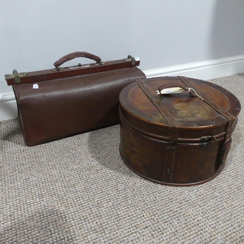 410 - A vintage leather Hat Box, 36cm diameter, together with a vintage leather Gladstone Bag (2)... 