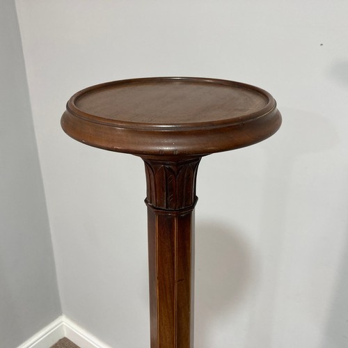 384 - An Edwardian mahogany Torchere, the circular top on tapering octagonal stem with moulded foliate mot... 