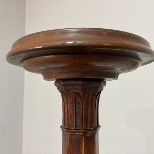 384 - An Edwardian mahogany Torchere, the circular top on tapering octagonal stem with moulded foliate mot... 