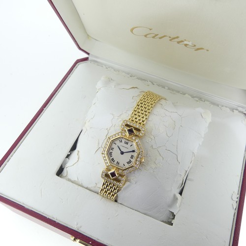 112 - Cartier Boutique Collection, a lady's 18k yellow gold ruby and diamond Cartier bracelet Wristwatch, ... 