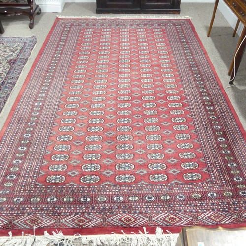 621 - Tribal Rugs; a large hand knotted fine Bokhara rug, wool pile on cotton base, red ground woven with ... 