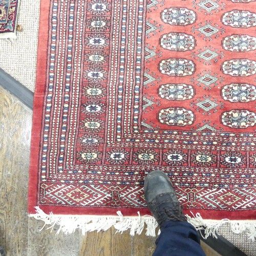 621 - Tribal Rugs; a large hand knotted fine Bokhara rug, wool pile on cotton base, red ground woven with ... 