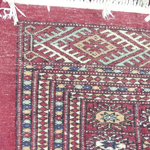 621 - Tribal Rugs; a large hand knotted fine Bokhara rug, wool pile on cotton base, red ground woven with ... 