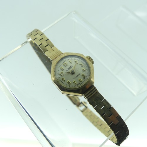 115 - A lady's 9ct gold Roamer Wristwatch, with Swiss movement, the octagonal case with circular silvered ... 