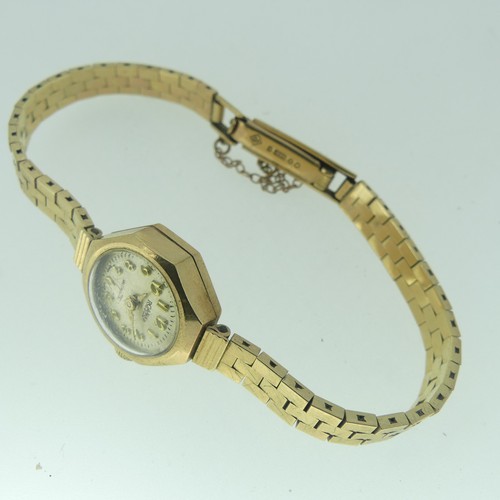 115 - A lady's 9ct gold Roamer Wristwatch, with Swiss movement, the octagonal case with circular silvered ... 