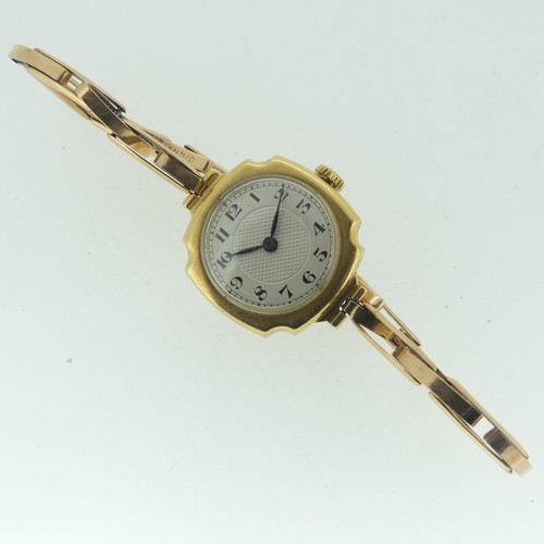 119 - A lady's 18ct gold Wristwatch, with Swiss movement, the circular silvered dial with black Arabic num... 