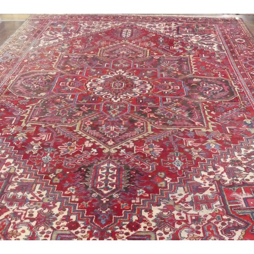 623 - Tribal Rugs; a large Shirvan hand-knotted rug, wool pile on cotton base, the red ground with bold ge... 