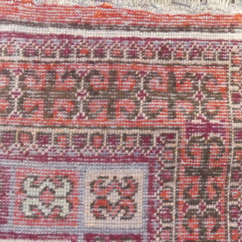 624 - Tribal Rugs; an Afghan rug, wool pile on cotton base, pink and rust ground woven with tekke and gul ... 