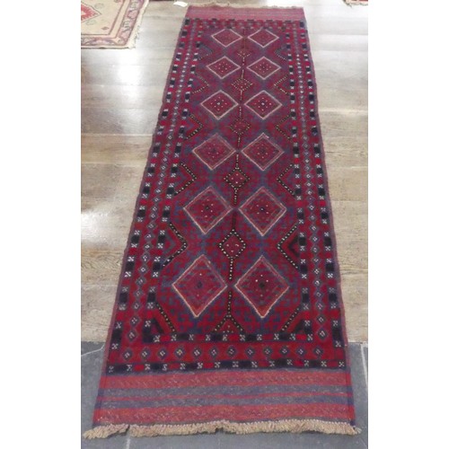 626 - Tribal Rugs; an Afghan runner, wool pile on wool base, burgundy ground with red diamond shaped patte... 