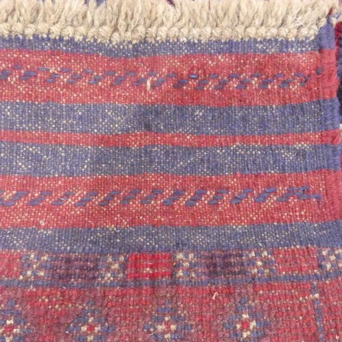 626 - Tribal Rugs; an Afghan runner, wool pile on wool base, burgundy ground with red diamond shaped patte... 