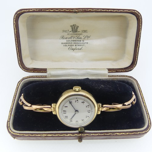 124 - A lady's 9ct gold Wristwatch, the circular silvered dial with black Arabic numerals, on 9ct gold Bri... 