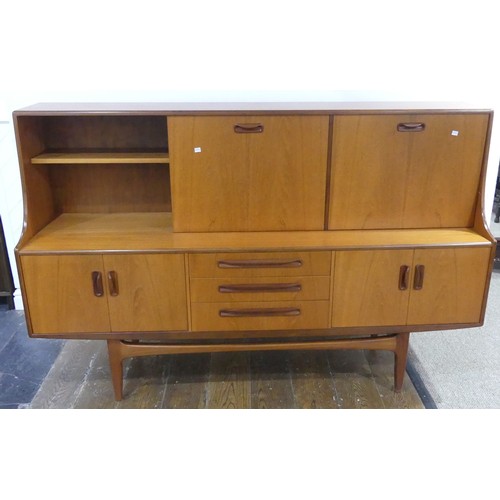 586 - A mid 20thC G-plan 'Fresco' teak Sideboard, with three central short drawers, two door cupboard sect... 