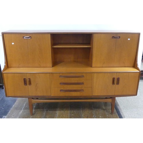 586 - A mid 20thC G-plan 'Fresco' teak Sideboard, with three central short drawers, two door cupboard sect... 