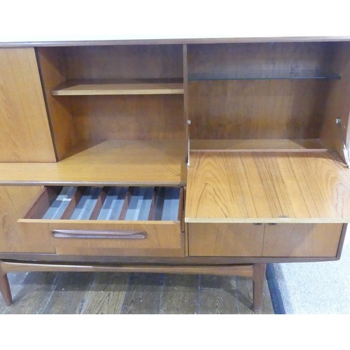 586 - A mid 20thC G-plan 'Fresco' teak Sideboard, with three central short drawers, two door cupboard sect... 