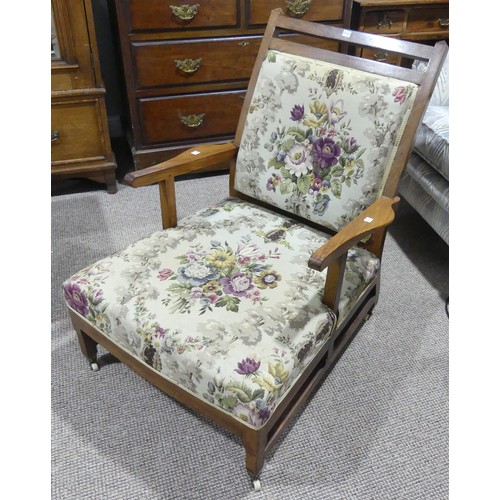 601 - An Edwardian walnut framed Armchair, on caps and castors, by P.E. Gane of Bristol, W 64cm x H 83cm x... 