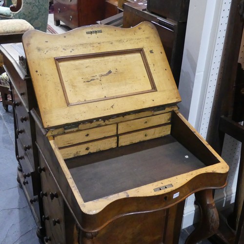 614 - A Victorian burr walnut Davenport, the fall front opening to reveal four small drawers, top altered ... 